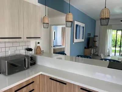 a kitchen with a counter top with a microwave at Swim up and Beach Getaway at White Sands in Punta Cana