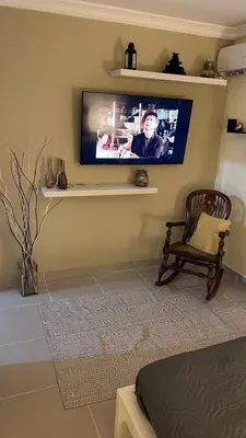 a living room with a flat screen tv on the wall at Apartamento cerca de todo en SDE in Santo Domingo