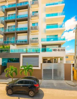 a car parked in front of a building at City Center, 2-BR Suite close to Shops, Restaurants, Bars and More in Santo Domingo