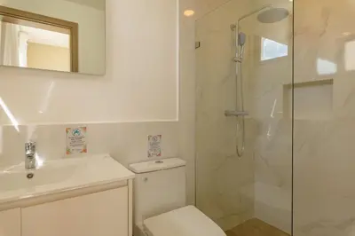 a bathroom with a shower and a toilet and a sink at PB 3 hab | con piscina privada + laguna cristalina in Punta Cana