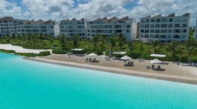 an aerial view of a resort with chairs and umbrellas at PB 3 hab | con piscina privada + laguna cristalina in Punta Cana