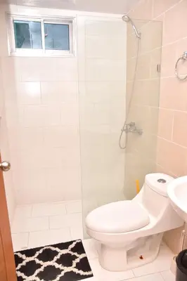a bathroom with a toilet and a shower at Luxury Pool Gym Basketball in Santiago de los Caballeros