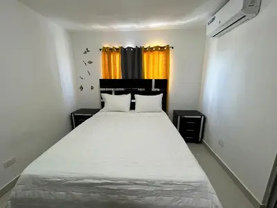 a bedroom with a large white bed in a room at Luxury Pool Gym Basketball in Santiago de los Caballeros