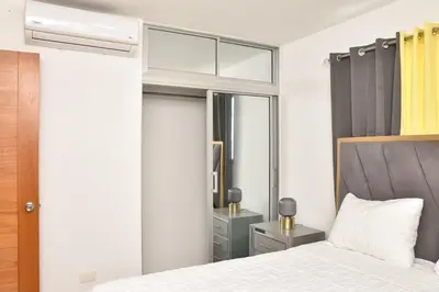 a bedroom with a bed and a mirror at Luxury Pool Gym Basketball in Santiago de los Caballeros