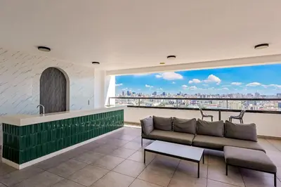a living room with a couch and a large window at Cozy 1BR Condo, Pool, Gym in Santo Domingo