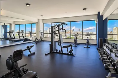 a gym with a view of a city skyline at Cozy 1BR Condo, Pool, Gym in Santo Domingo