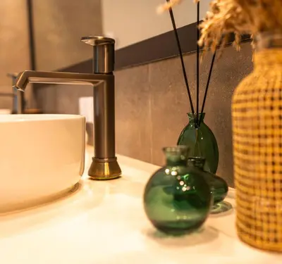 a counter with two green vases and a coffee cup at La Pala Suites in Las Terrenas