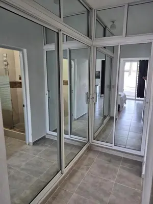 a room with glass doors and a tiled floor at ENE Apartments Nagua 1B in Nagua