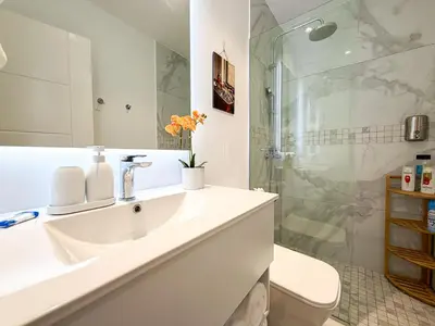 a bathroom with a sink and a shower at Cana Rock Penthouse Golf Views & Infinity Pool in Punta Cana