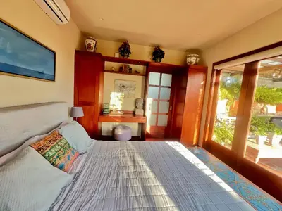 a bedroom with a large bed and a window at Lux 2-Level Townhouse with Stunning Historic Views in Santo Domingo
