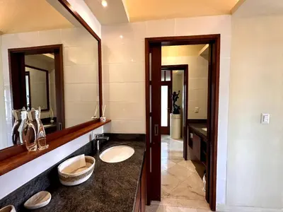 a bathroom with two sinks and a mirror at Lux 2-Level Townhouse with Stunning Historic Views in Santo Domingo