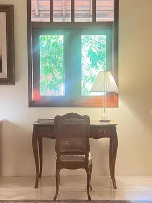 a desk with a lamp and a chair in front of a window at Lux 2-Level Townhouse with Stunning Historic Views in Santo Domingo