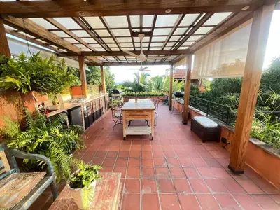 a patio with a table and benches and plants at Lux 2-Level Townhouse with Stunning Historic Views in Santo Domingo