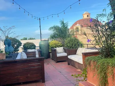 a patio with furniture and a building with a dome at Lux 2-Level Townhouse with Stunning Historic Views in Santo Domingo