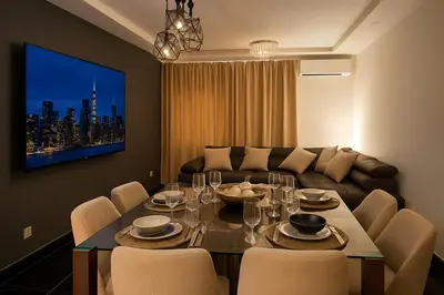 a living room with a table and a couch at Comfortable and Attractive Apartment in Ensanche Savica de Mendoza