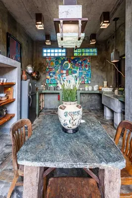 a kitchen with a table with a vase on it at House Cottage in Caribbean Mountains 2