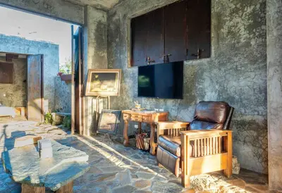 a living room with a couch and a table at House Cottage in Caribbean Mountains 2