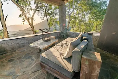 a large bed sitting on a patio with a table at House Cottage in Caribbean Mountains 2