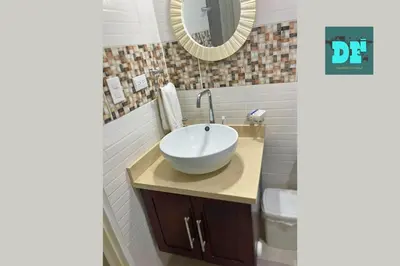 a bathroom with a white sink and a mirror at Villa Eli in Puerto Plata