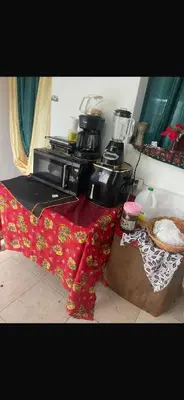 a kitchen with a counter top with a microwave and a table at santo domingo airport villa in Reparto Esther Rosario