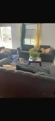a living room with couches and a table with a plant at santo domingo airport villa in Reparto Esther Rosario