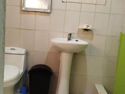 a bathroom with a sink and a toilet at Hotel El Almendro in Pedernales