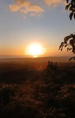a sunset from the top of a hill at Hotel El Almendro in Pedernales