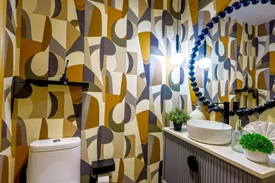 a bathroom with a toilet and a mirror at Elegant and Cozy 1BD Condo in Santo Domingo