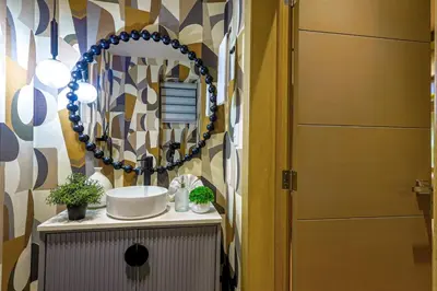 a bathroom with a sink and a mirror at Elegant and Cozy 1BD Condo in Santo Domingo
