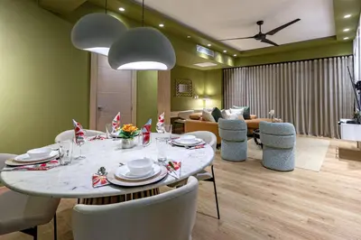 a dining room with a table and chairs and a couch at Elegant and Cozy 1BD Condo in Santo Domingo