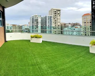 a balcony with a green lawn on a building at Chic Elegant City Center Condo in Santo Domingo