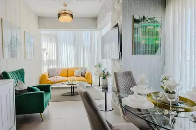 a living room with a yellow couch and a table at Chic Elegant City Center Condo in Santo Domingo