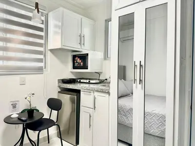 a small kitchen with a small table and a small room at RoblestRoom in Santiago de los Caballeros