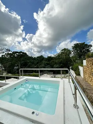 a hot tub on the roof of a house at apartamento exclusivo con jacuzzi, piscina y vista al lago in Las Terrenas