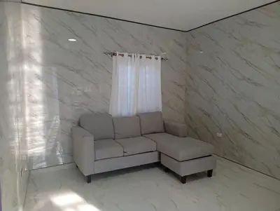 a living room with a couch and a chair at Villa colombia in Miches