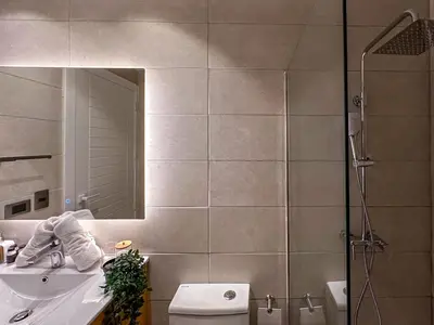 a bathroom with a toilet and a sink and a mirror at Beautiful brand new Beach Condo w Picuzzi in Punta Cana