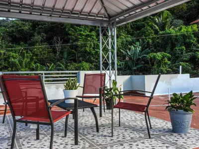 two chairs and a table on a patio at Majestic View Apartment II in San Felipe de Puerto Plata
