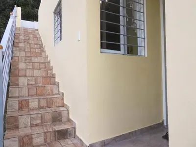 a staircase leading up to a house with a window at Majestic View Apartment II in San Felipe de Puerto Plata