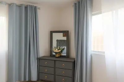 a dresser with a mirror on top of it next to a window at Bright & Spacious En-suite Room - Santo Domingo Este in Cancino
