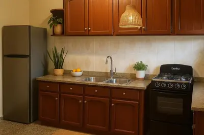 a kitchen with a sink and a refrigerator at Bright & Spacious En-suite Room - Santo Domingo Este in Cancino