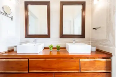 two sinks in a bathroom with two mirrors at Buganvilla 252 Cocotal Villa - 4BR, Private Pool, Jacuzzi, Golf View in Punta Cana