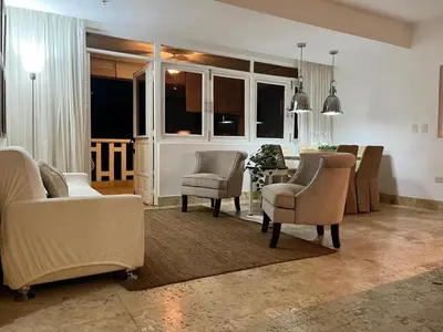 a living room with chairs and a dining room at Antiguo Dominican Bay in Cuevas