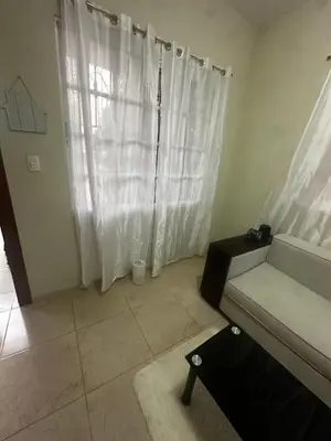 a living room with white curtains and a couch at Espacioso Casa en Puerto Plata cerca de La Playa 4 camas 3 baños Agua caliente Aire condicionado Wi-Fi in Puerto Plata