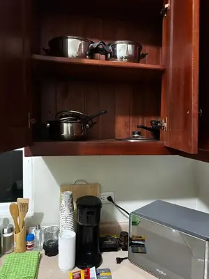 a kitchen counter with two pots and a microwave at Espacioso Casa en Puerto Plata cerca de La Playa 4 camas 3 baños Agua caliente Aire condicionado Wi-Fi in Puerto Plata