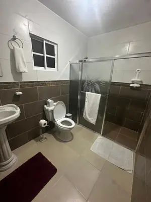 a bathroom with a shower and a toilet and a sink at Espacioso Casa en Puerto Plata cerca de La Playa 4 camas 3 baños Agua caliente Aire condicionado Wi-Fi in Puerto Plata