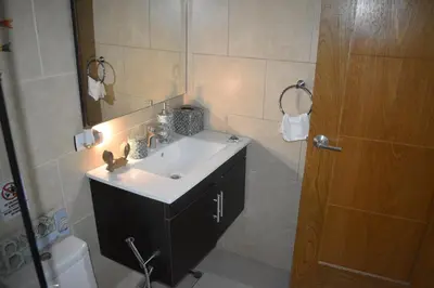 a bathroom with a sink and a mirror and a shower at El Sueño, Breathtaking Ocean Front, Juan Dolio in Guayacanes