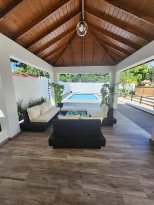 a living room with couches and a pool at Cerro hermoso in Santiago de los Caballeros