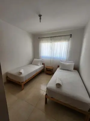 a bedroom with two beds and a window at Cerro hermoso in Santiago de los Caballeros