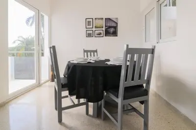 a dining room with a black table and chairs at Casa Mango- Relax - Pool Stunning Views in San Felipe de Puerto Plata