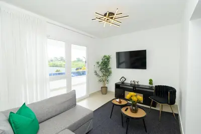 a living room with a couch and a tv at Coastal Comfort in Bayahibe 2BR 2BA Carribean Rose in San Rafael del Yuma